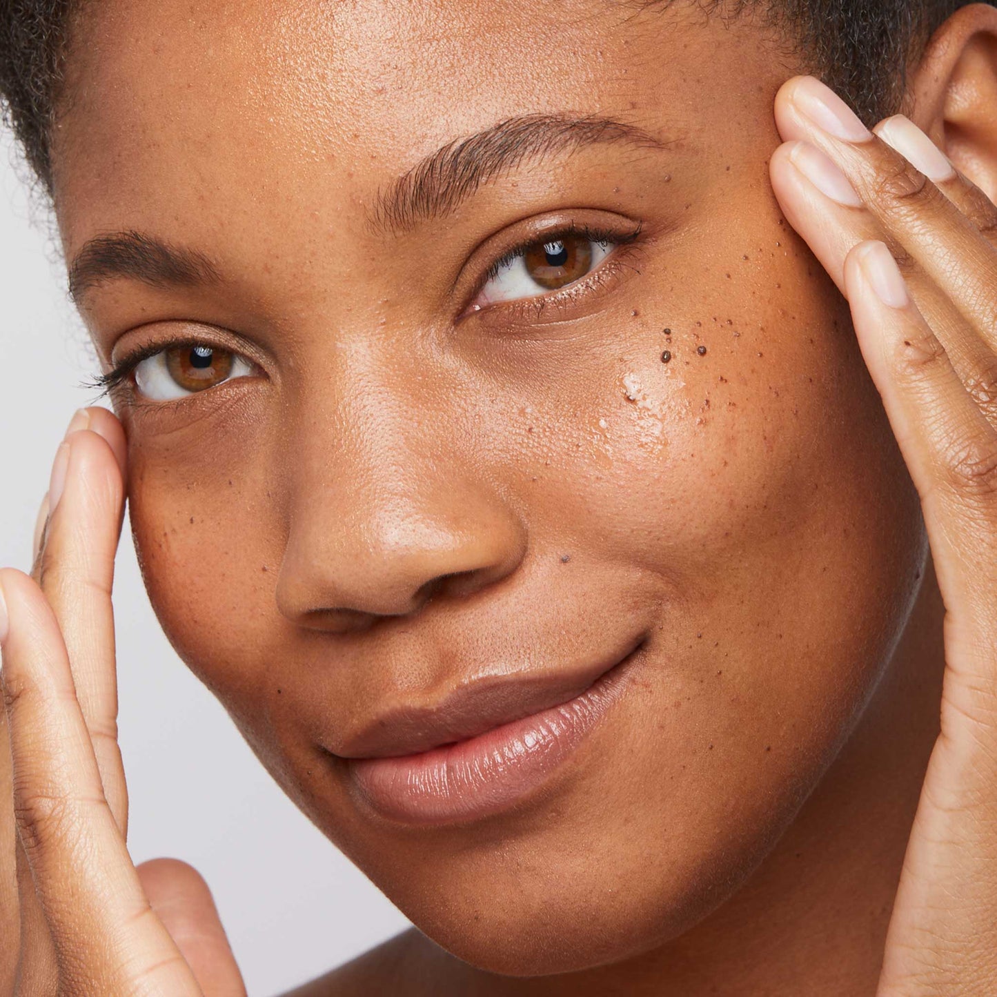 woman applying age bright clearing serum 