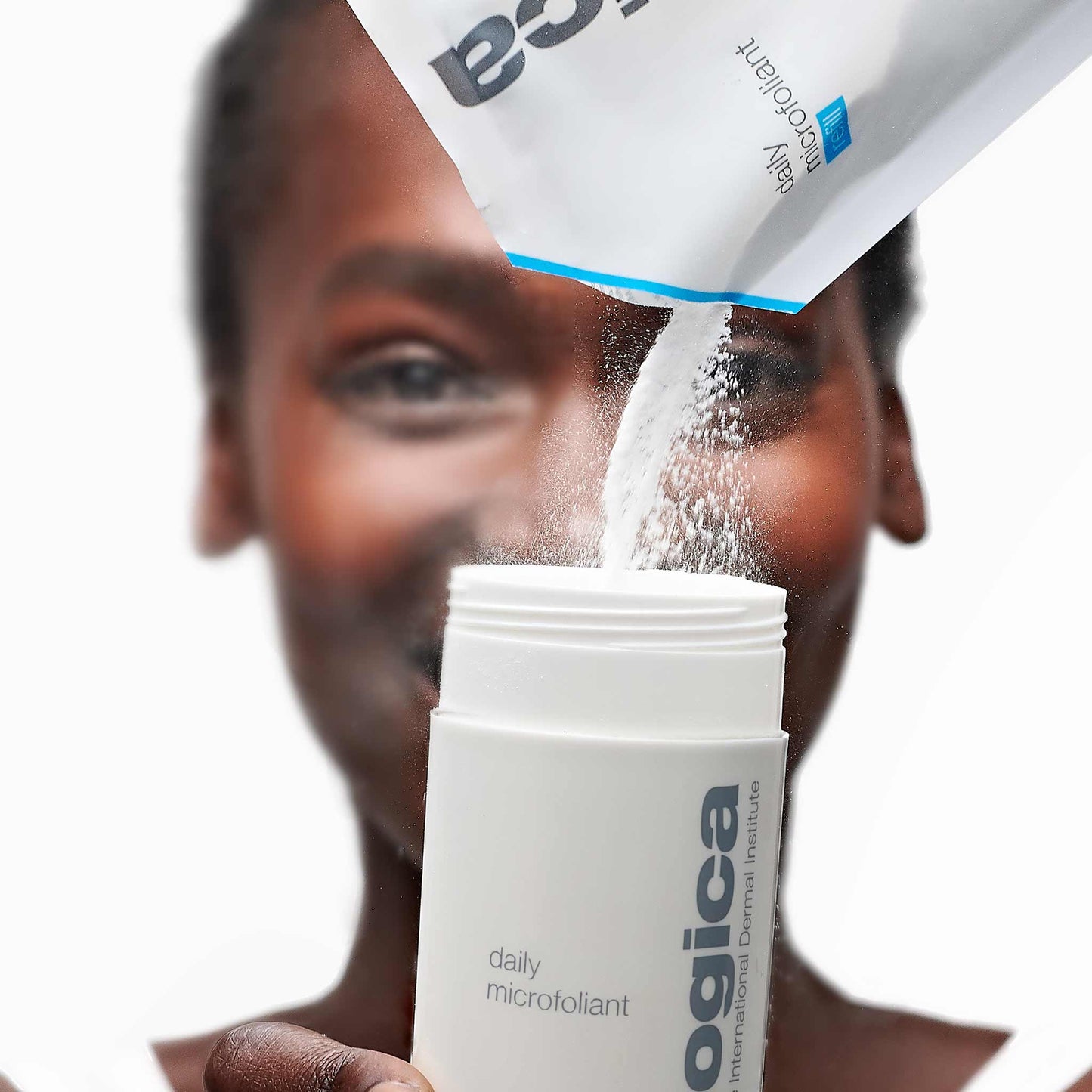 woman dispensing daily microfoliant refill pack into daily microfoliant bottle