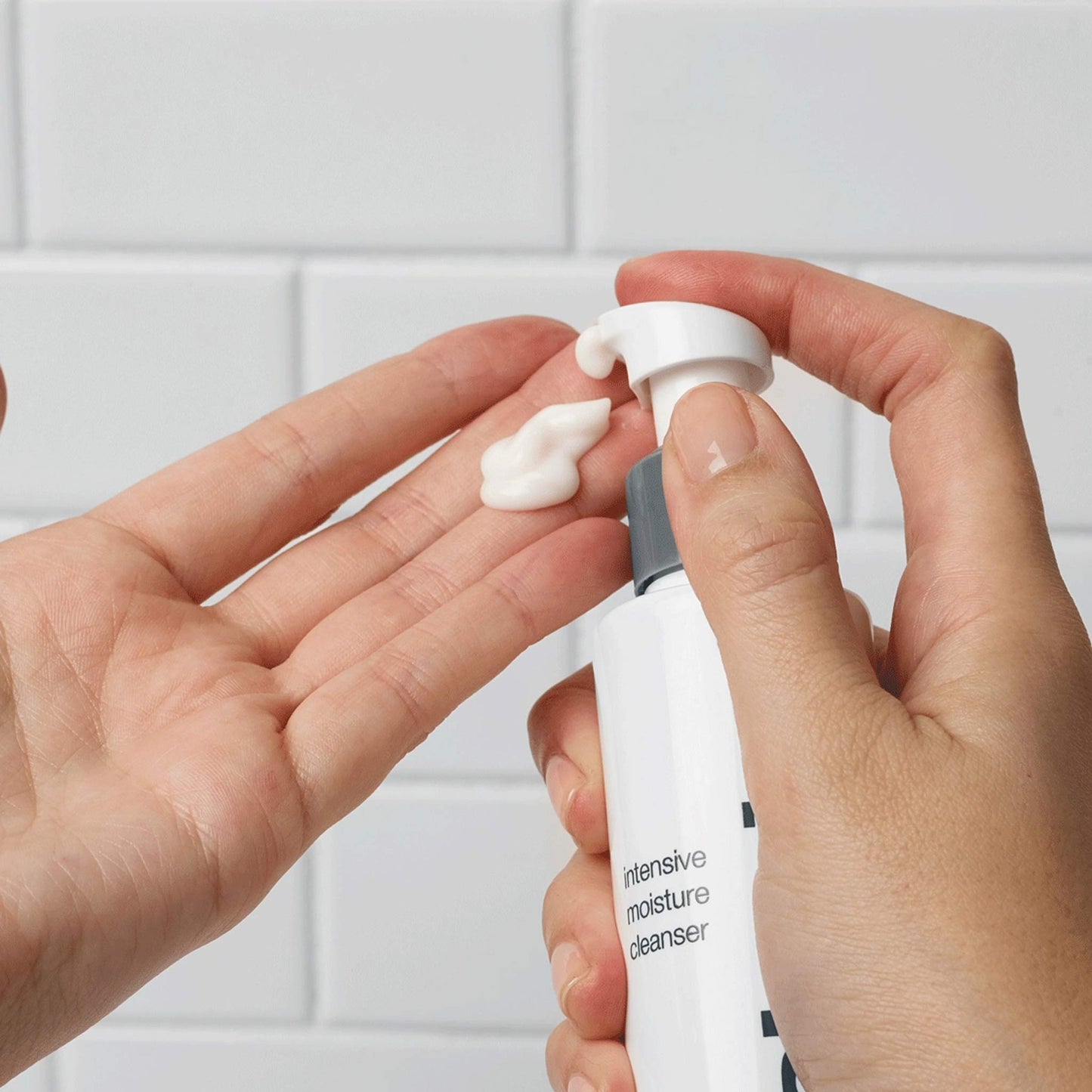 intensive moisture cleanser being dispensed onto fingertips 