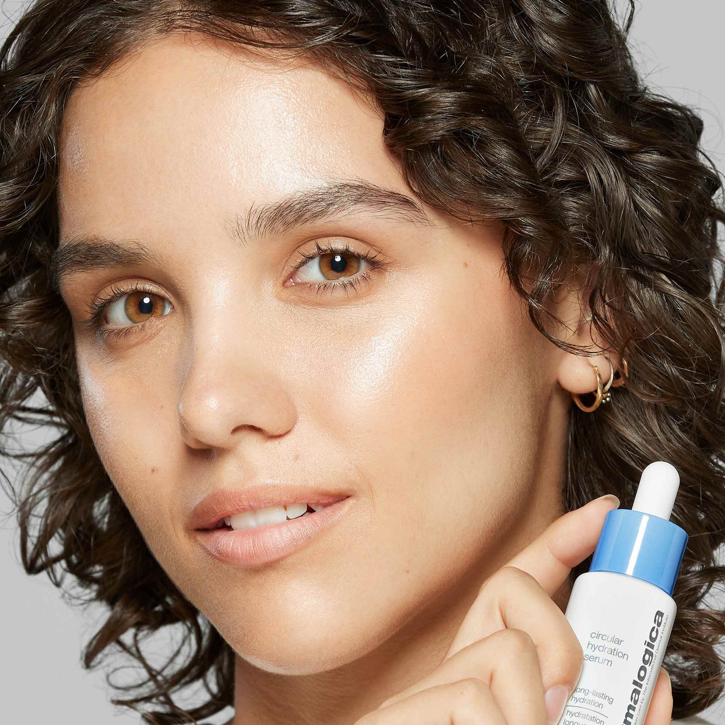 woman holding circular hydration serum 